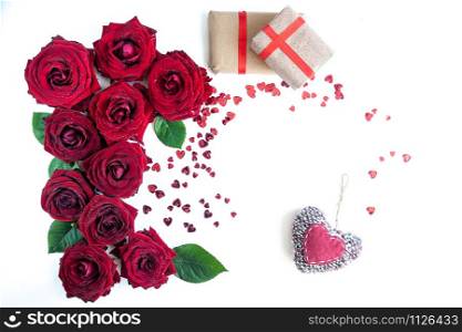 Flat Lay Background, flower pattern, Valentine&rsquo;s Day, the theme of lovers. Red roses and gifts with ribbons on a white background, isolated