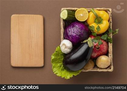 flat lay basket fresh vegetables with chopping board