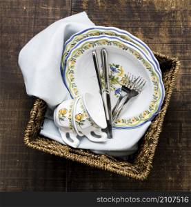 flat lay basket with floral tableware
