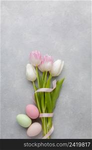 flat lay beautiful tulips with ribbon colorful easter eggs