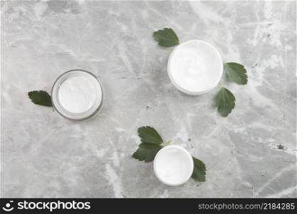 flat lay body cream products marble background