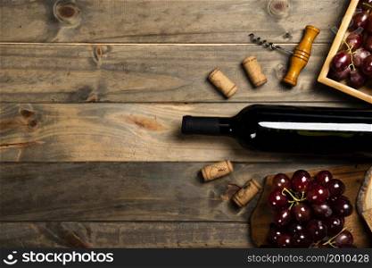 flat lay bottle wine surrounded by corks red grapes
