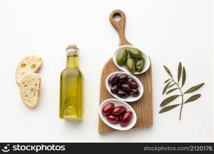 flat lay bread slices purple red green olives with olive oil bottle
