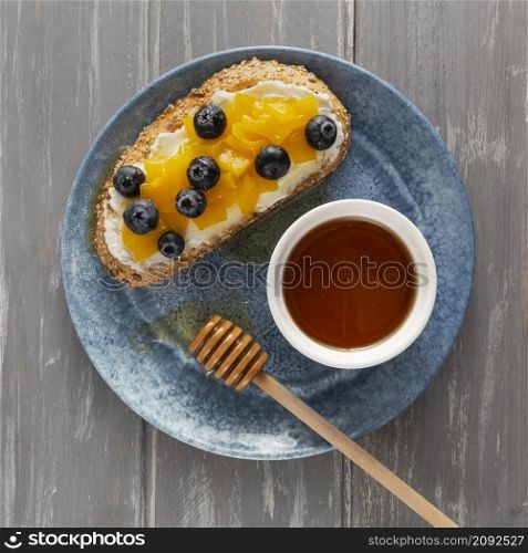 flat lay bread with cream cheese fruits plate with honey