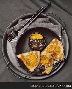 flat lay breakfast crepes with jam bed