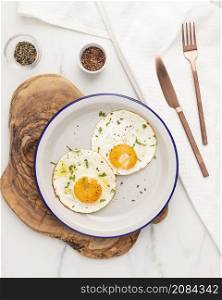 flat lay breakfast fried eggs plate with cutlery