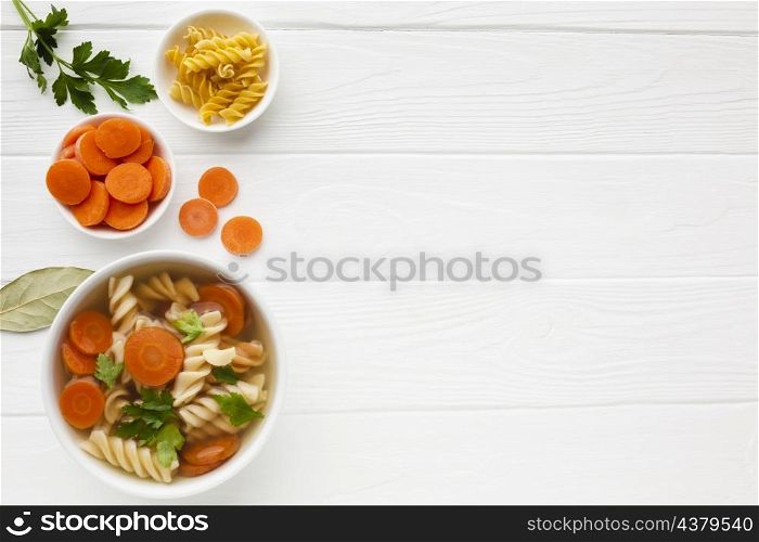 flat lay broccoli carrots fusilli bowl with copy space