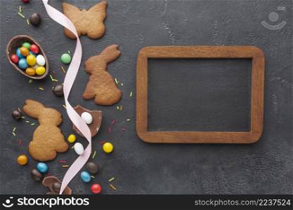 flat lay bunny shaped cookies chocolate eater eggs with blackboard