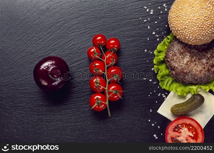 flat lay burger ingredients slate background