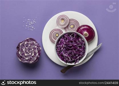 flat lay cabbage bowl with onion plate knife