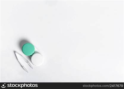 flat lay case contact lenses with tweezers copy space