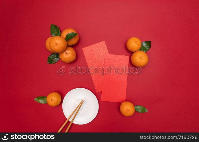 Flat lay Chinese lunar new year traditional food and offering red envelope on table top