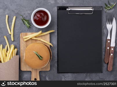 flat lay clipboard beside hamburger fries