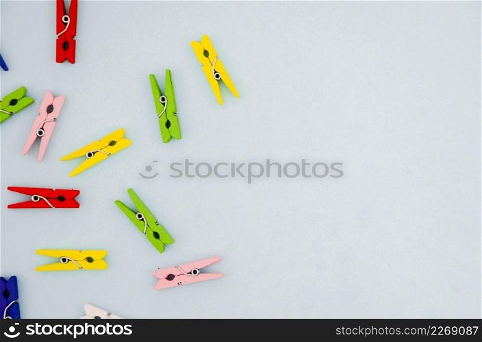 flat lay colorful clothes pins with copyspace