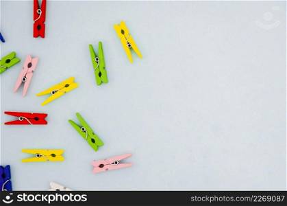 flat lay colorful clothes pins with copyspace