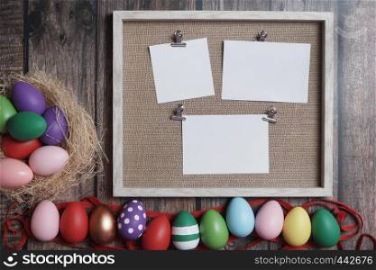 Flat-lay colorful Easter eggs on wooden table copy-space