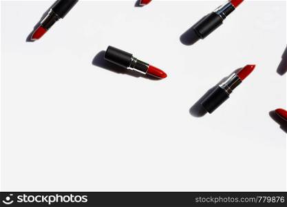 Flat lay composition, Lipsticks on white background with shadow. Beautiful Make-up concept with copy space