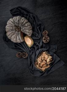 Flat Lay composition with delicious of Homemade crispy pumpkin chips on Black stone texture. Top view.