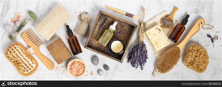 Flat lay composition with lavender flowers and natural cosmetic products on white marble background, skin care and eco friendly lifestyle concept, banner composition