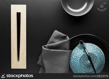 flat lay crockery with chopsticks teapot