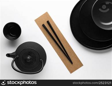 flat lay dark dinnerware with teapot