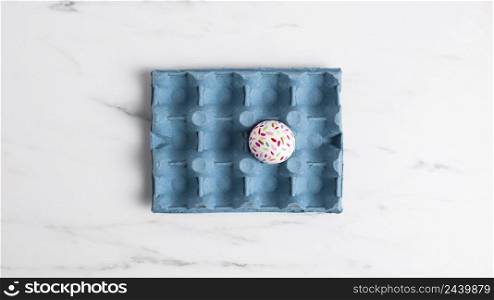 flat lay decorated easter egg carton