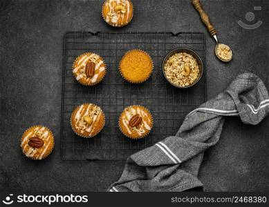 flat lay delicious muffins with nuts cooling rack