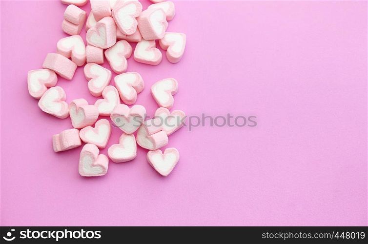 Flat lay design top view a group of heart shape marshmallows on pink background with copy space for web banner template design, fudge dessert menu restaurant, flyer, brochure
