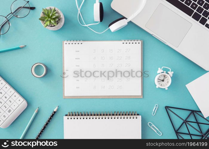 flat lay desk calendar blue background. High resolution photo. flat lay desk calendar blue background. High quality photo