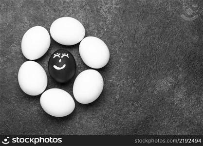 flat lay different colored eggs with faces black lives matter movement copy space
