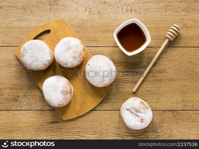 flat lay doughnuts with honey dipper