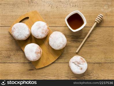 flat lay doughnuts with honey dipper