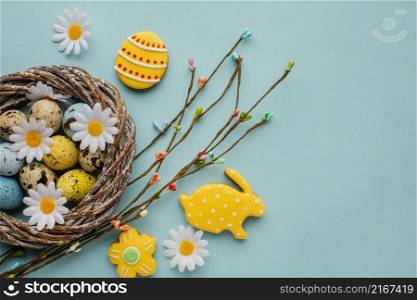 flat lay easter eggs basket with chamomile flowers