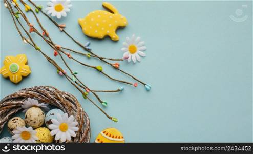 flat lay easter eggs basket with chamomile flowers bunny