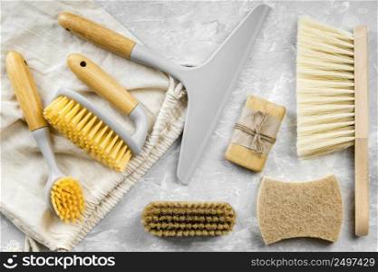 flat lay eco friendly cleaning products with assortment brushes