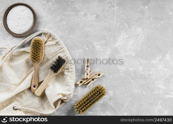 flat lay eco friendly cleaning products with baking soda brushes