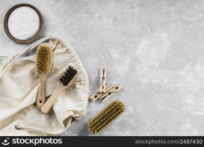 flat lay eco friendly cleaning products with baking soda brushes