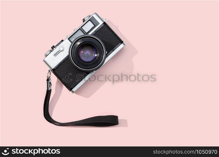 Flat lay film camera isolated on pink background. Copy space. Photography or photographer concept