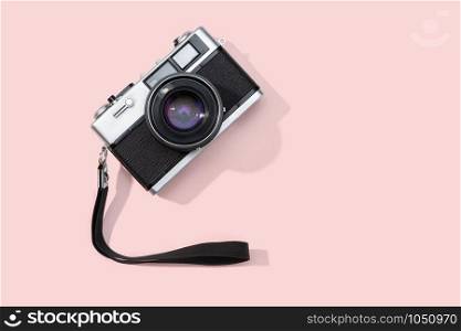 Flat lay film camera isolated on pink background. Copy space. Photography or photographer concept