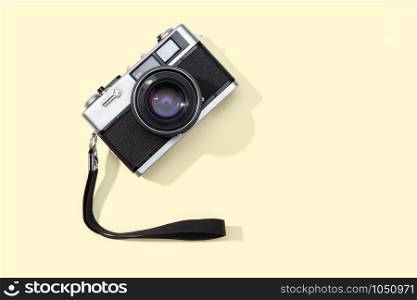 Flat lay film camera isolated on yellow background. Copy space. Photography or photographer concept