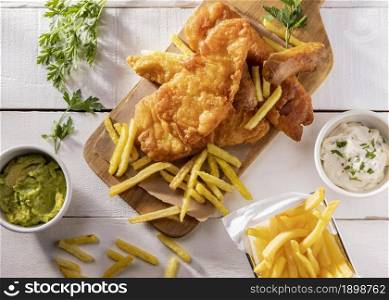 flat lay fish chips chopping board with sauce. Resolution and high quality beautiful photo. flat lay fish chips chopping board with sauce. High quality beautiful photo concept