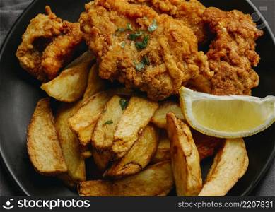 flat lay fish chips plate with lemon slice