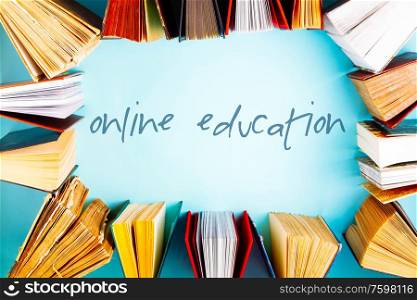 Flat lay frame of old books on blue background, online ducation concept. Pile of old books