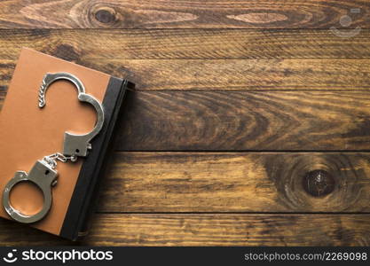 flat lay frame with book handcuffs