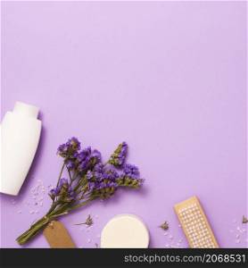 flat lay frame with white bottle lilac flower