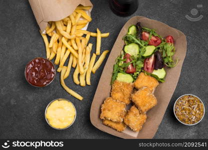 flat lay fried chicken nuggets with salad french fries