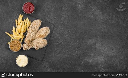 flat lay fried chicken with french fries sauces