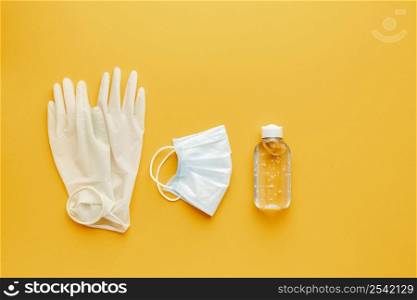 flat lay gloves with medical mask hand sanitizer