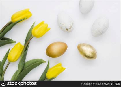 flat lay golden easter eggs with flowers