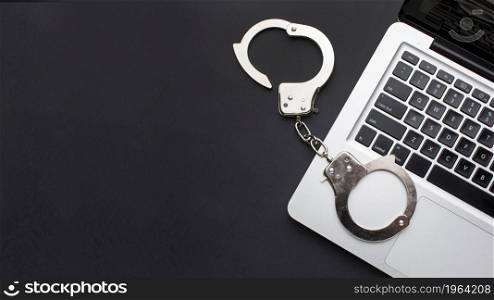 flat lay handcuffs with laptop copy space. High resolution photo. flat lay handcuffs with laptop copy space. High quality photo